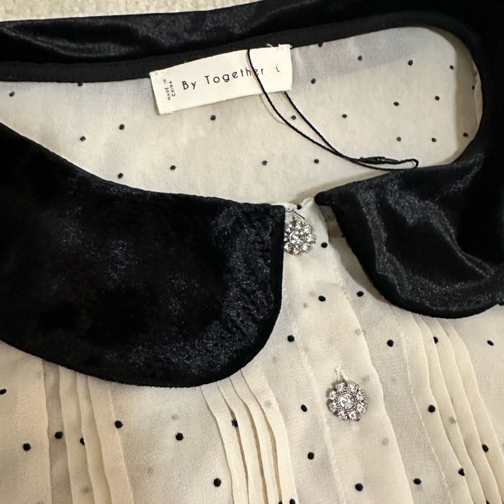 Cream polka dot crepe blouse with black velvet collar and rhinestone buttons
